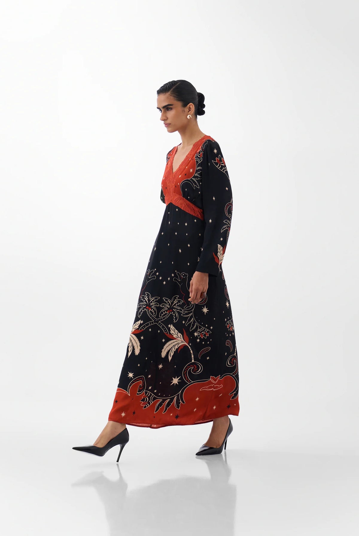 NOIB Aura Old Rose printed maxi dress with long sleeves and contrasting orange-red bodice – side model view.