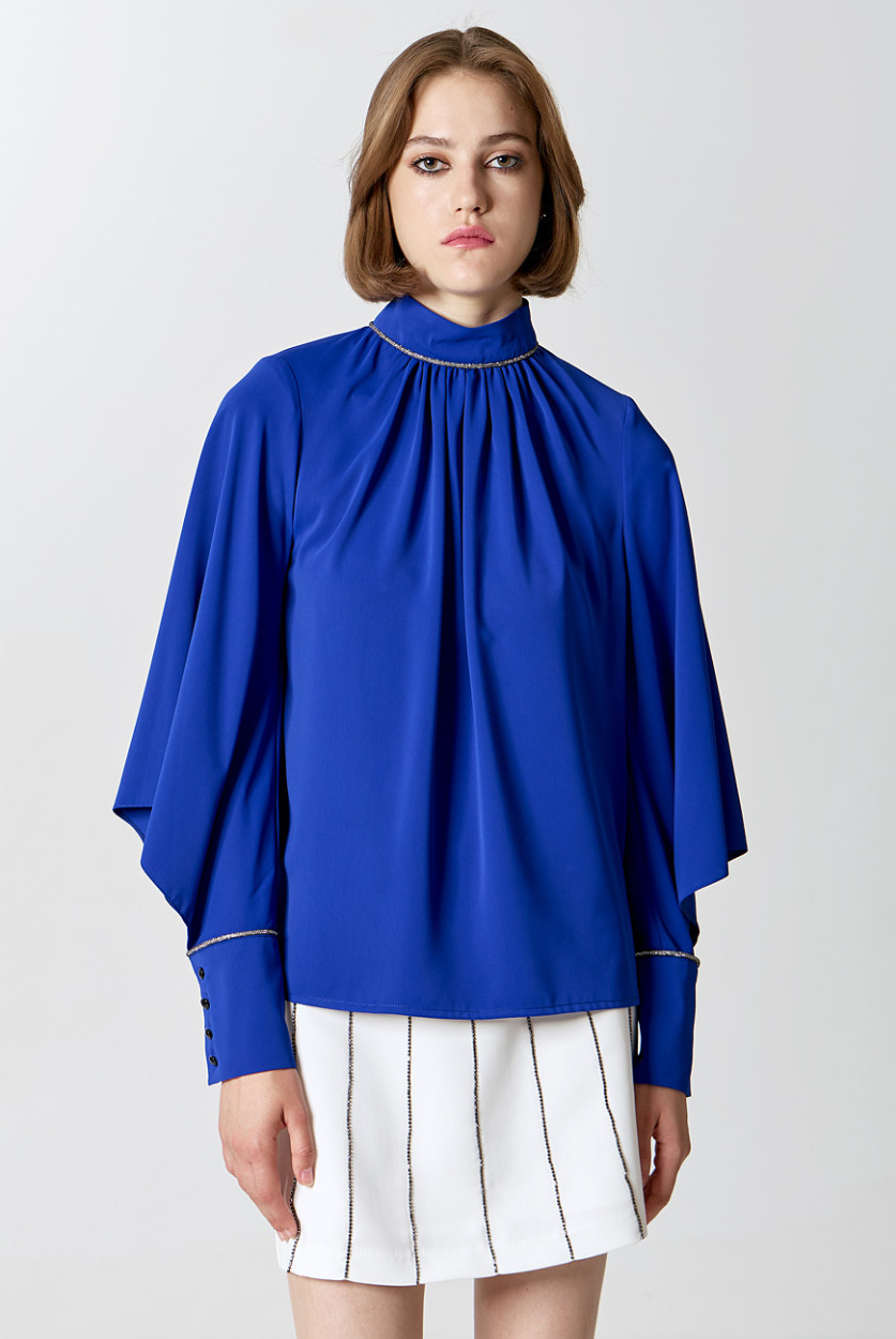 Model wearing Access Fashion cobalt blue diamanté trim blouse and short skirt