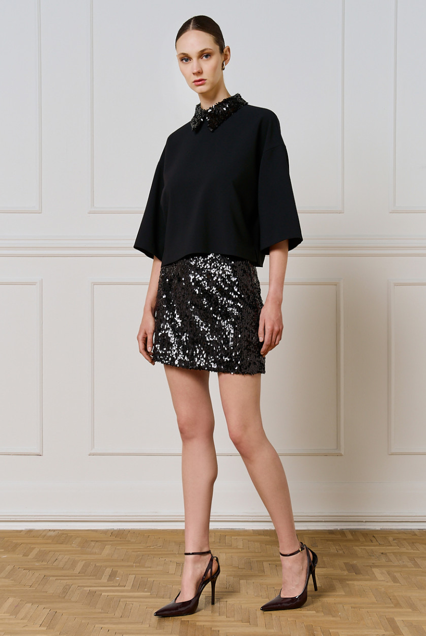 Access Fashion black sequin collar top styled with black sequin mini skirt and heels, full outfit.