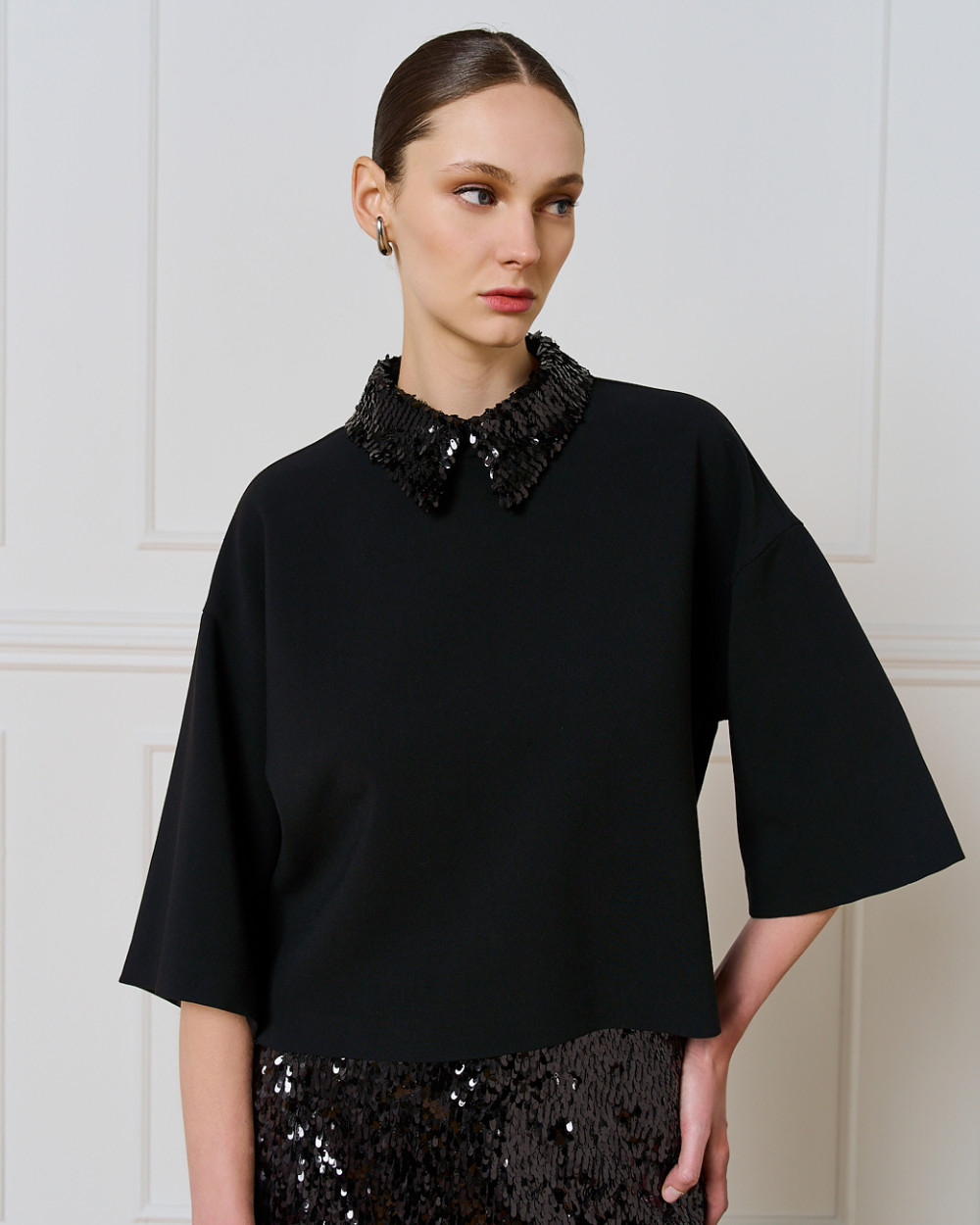 Access Fashion relaxed black top with wide 3/4 sleeves and detachable sequin collar, front three-quarter view.