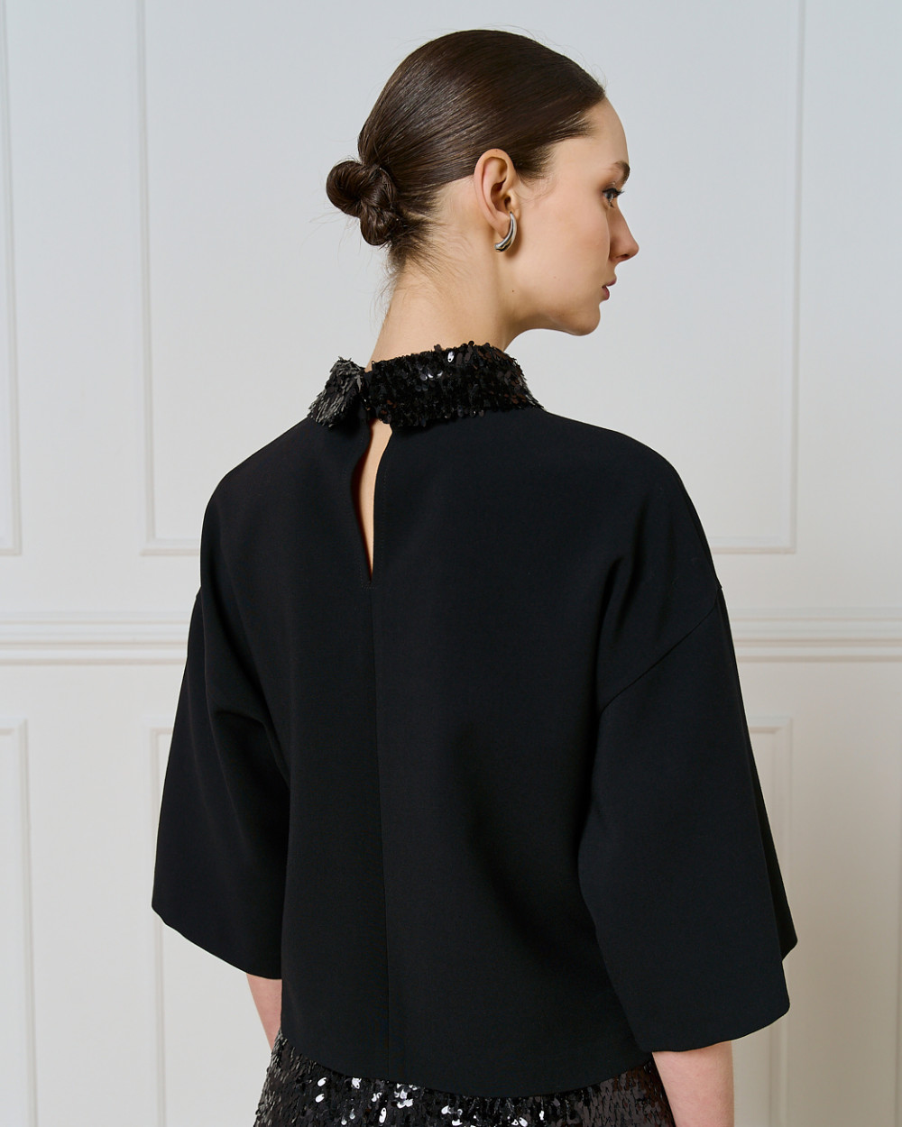 Access Fashion black top back view showing keyhole opening and detachable sequin collar.