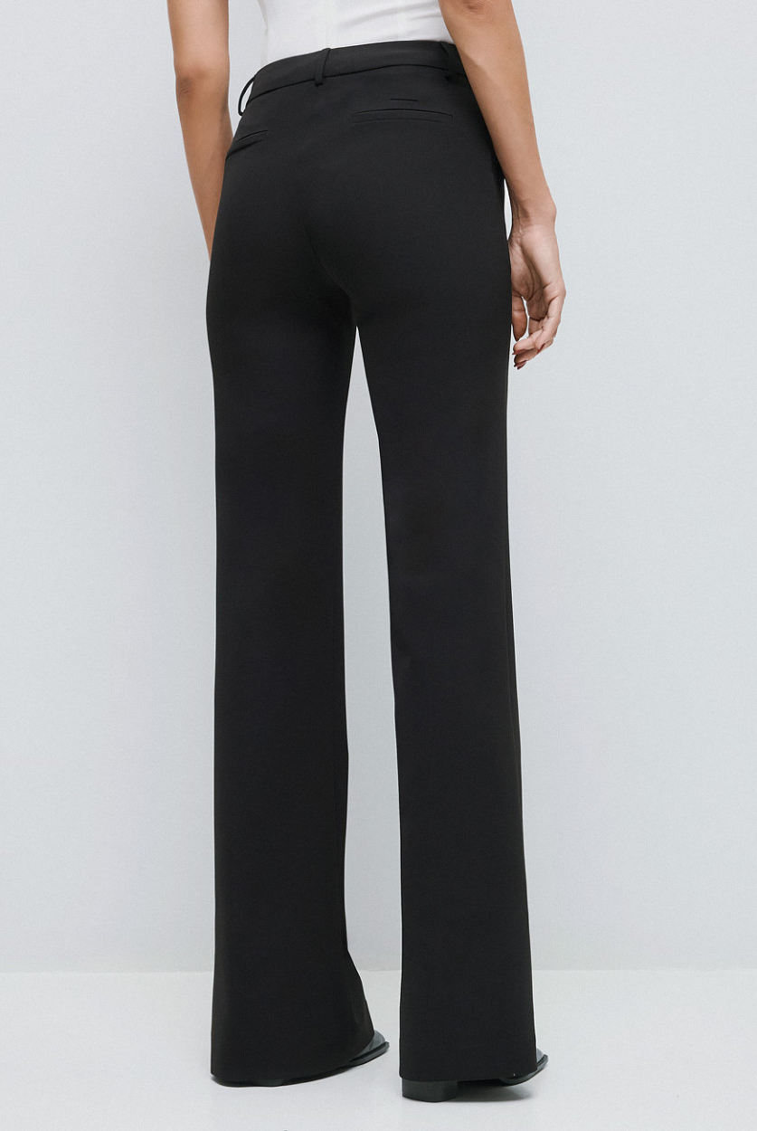 Access Fashion high waisted black flared trousers back view.
