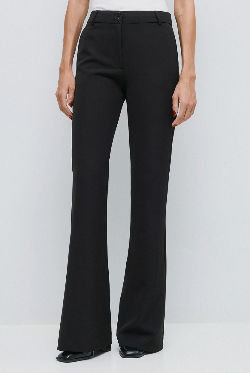 Access Fashion high waisted black flared trousers styled with white top.