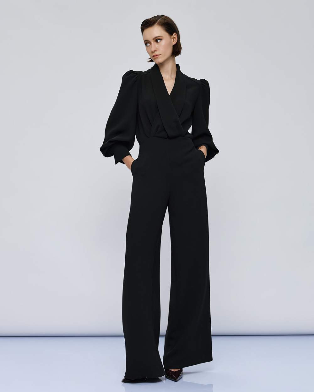Access Fashion Black Puff Sleeve Jumpsuit back view with keyhole opening and long wide legs.