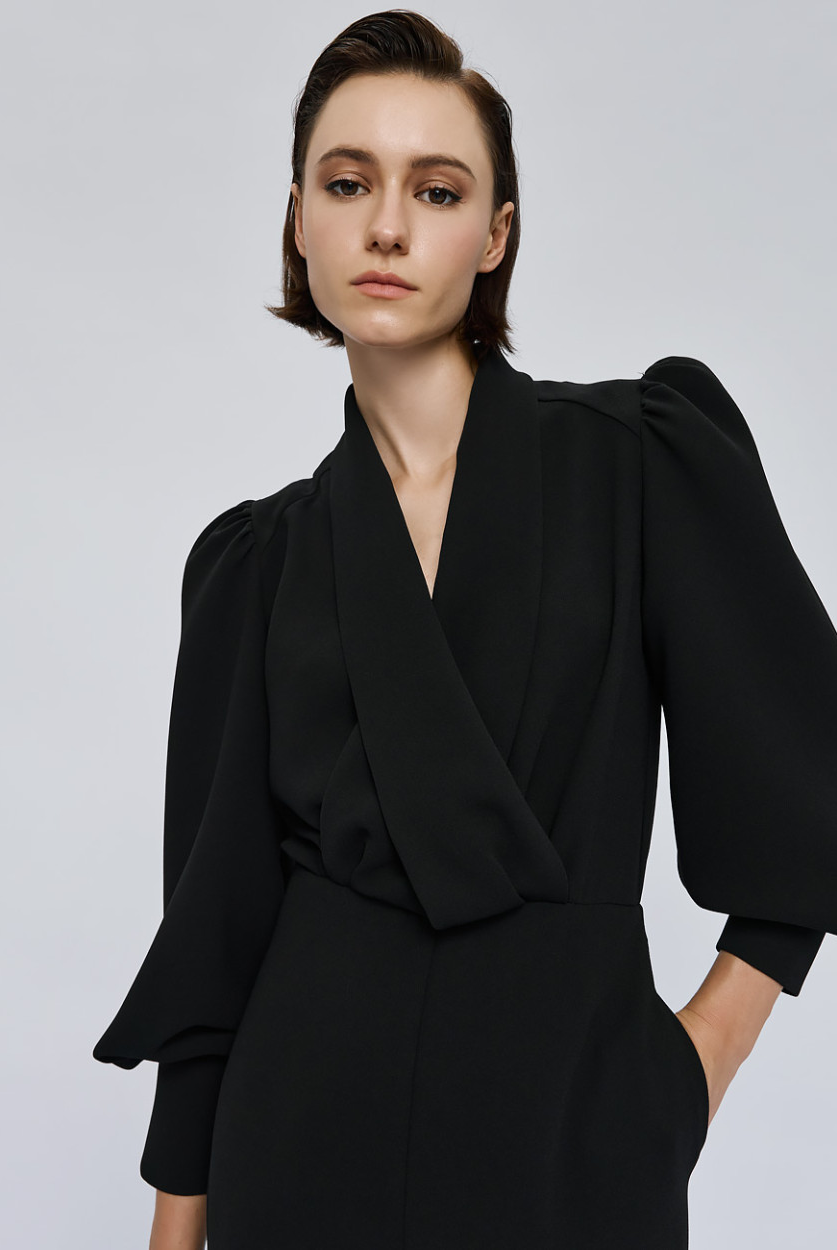 Access Fashion Black Puff Sleeve Jumpsuit close up of wrap neckline and dramatic puff sleeves.