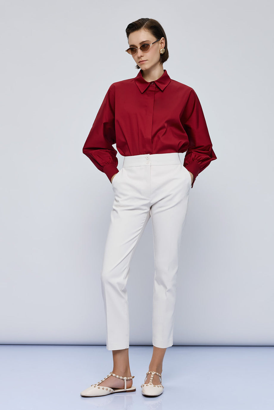 Full-length view of red Access Fashion shirt styled with white trousers