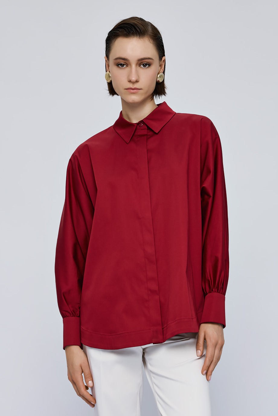 Access Fashion red shirt cuff with button detail close-up