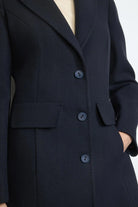 Side profile of Bariloche Cobijo navy women’s overcoat With pockets