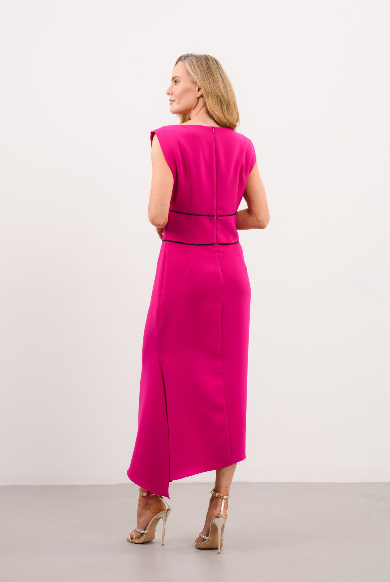 Back view of Caroline Kilkenny Adelle cerise asymmetric midi dress