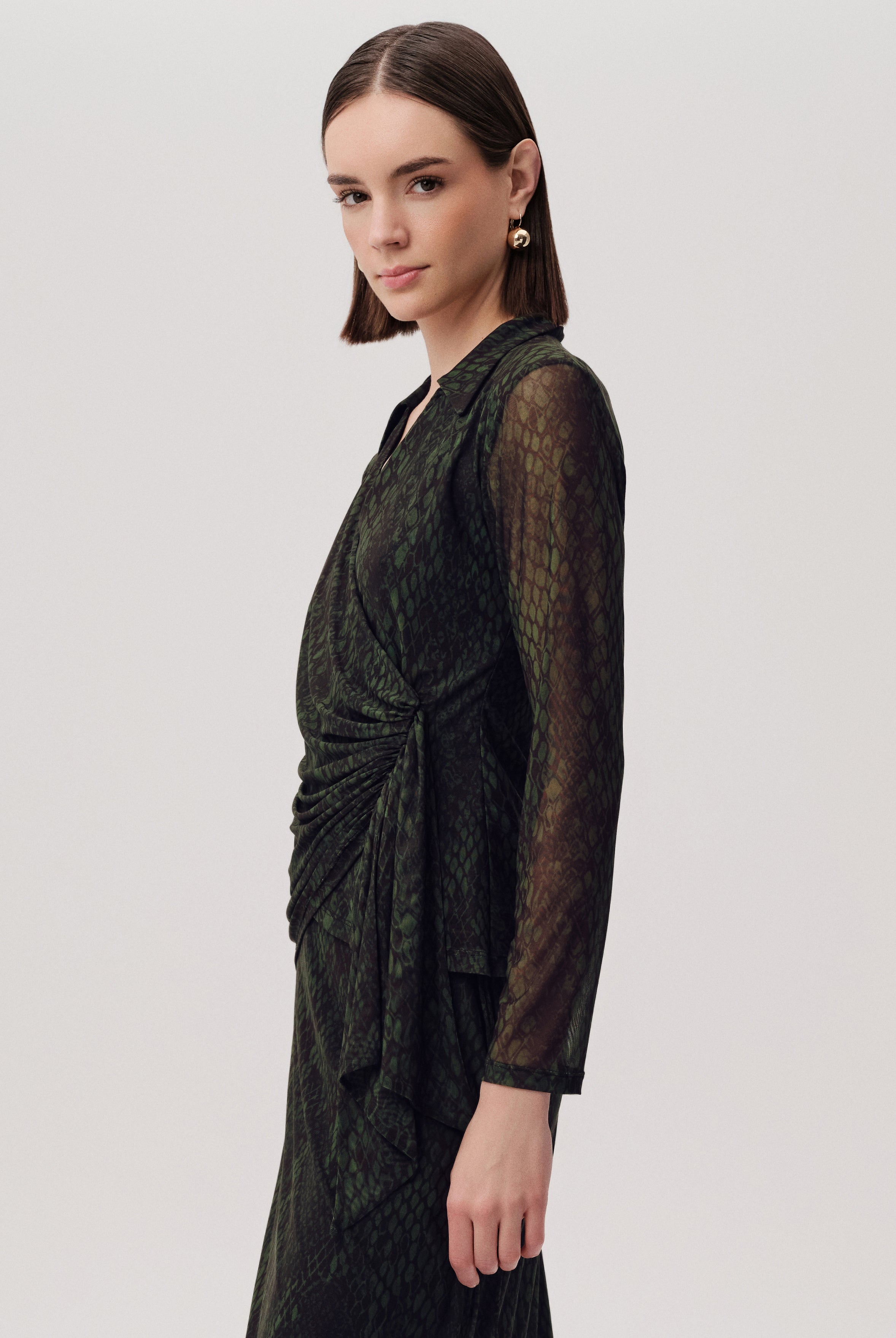 Side angle of Exquise Kinslee K wrap blouse in green snake print