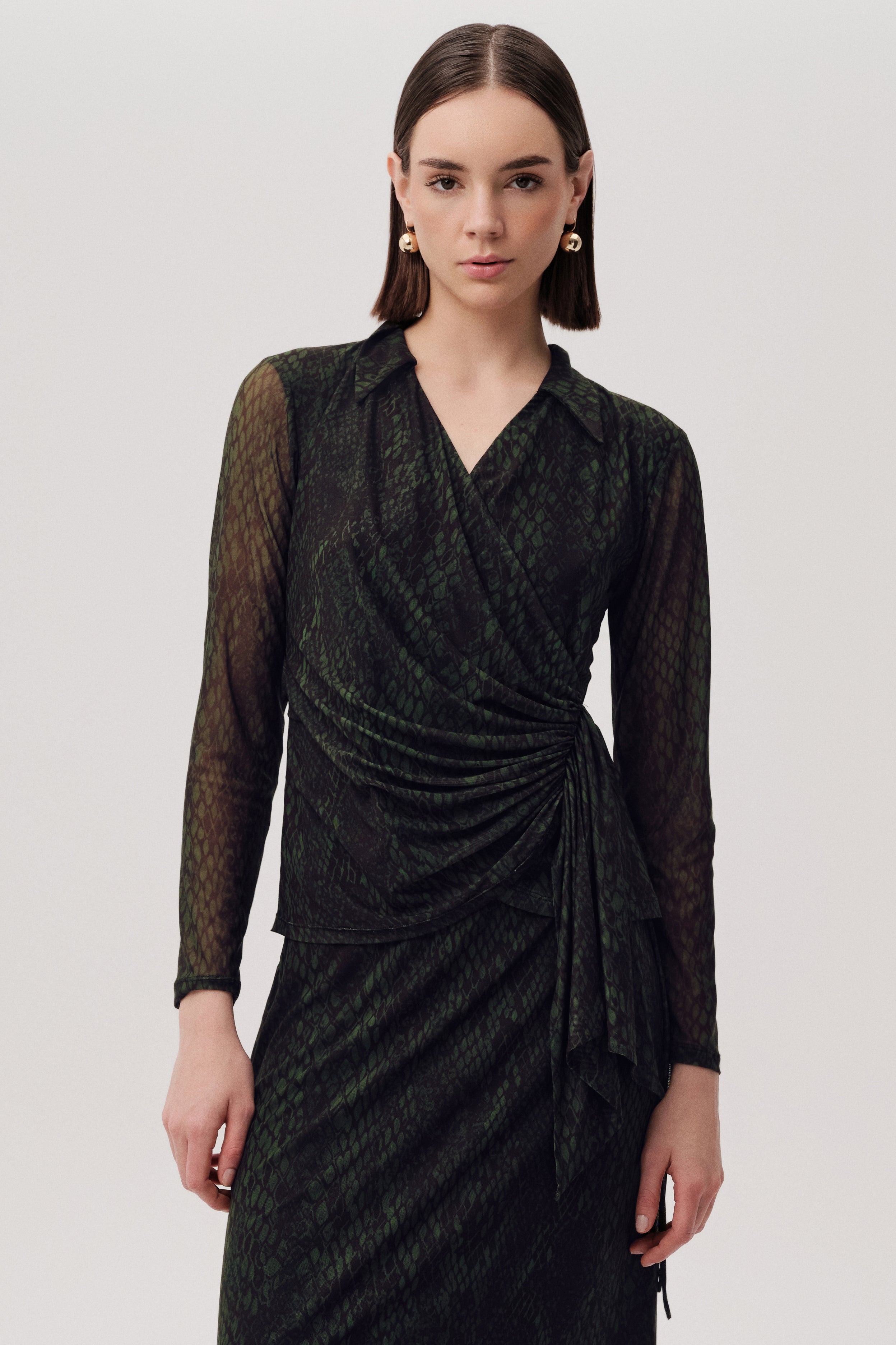 Green snake print blouse by Exquise with side drape and long sleeves