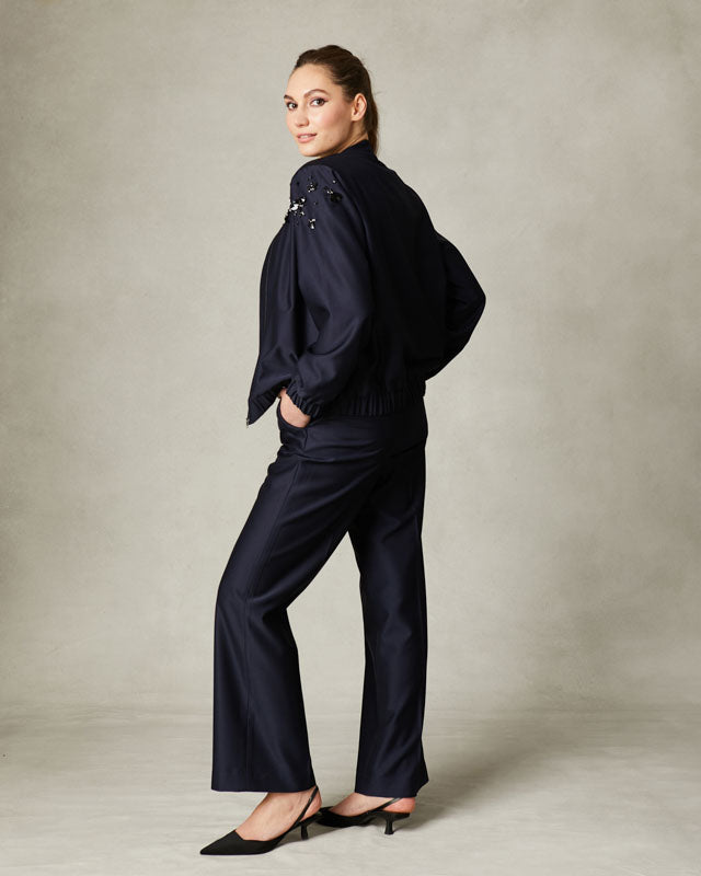 Tailored navy trousers with high-rise waist and side pockets.
