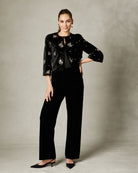 Model wearing Fee G Athena cropped black velvet beaded jacket