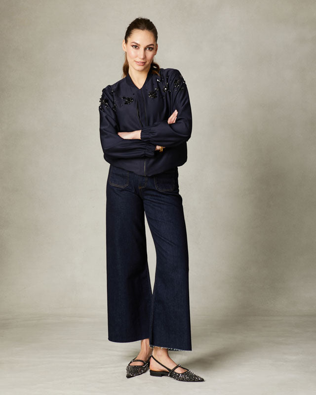 Navy bomber jacket with hand-beaded embellishment and zip front.