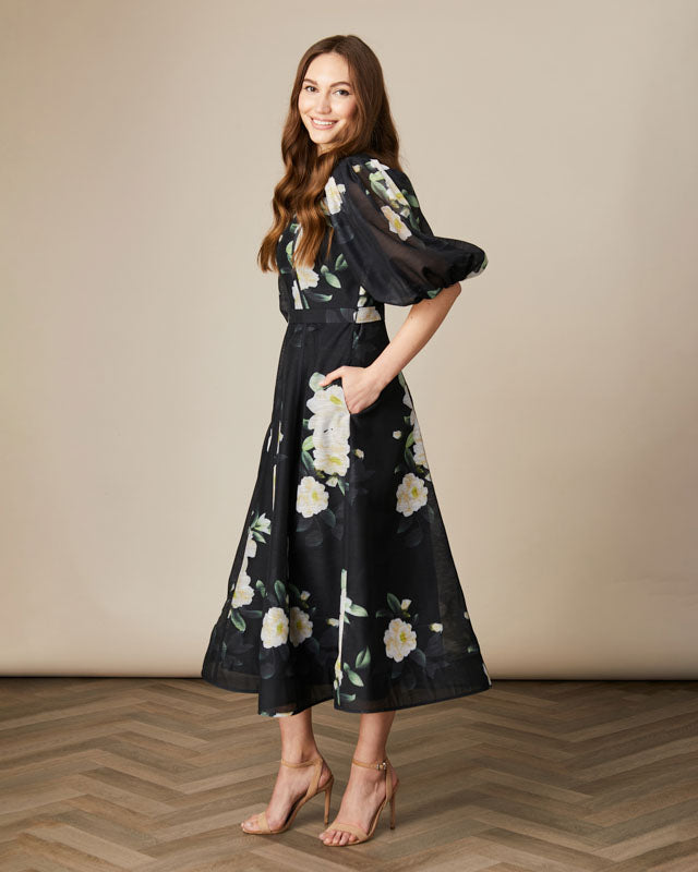 Side view of Fee G Kate dress in painterly black floral print showing puff sleeves.