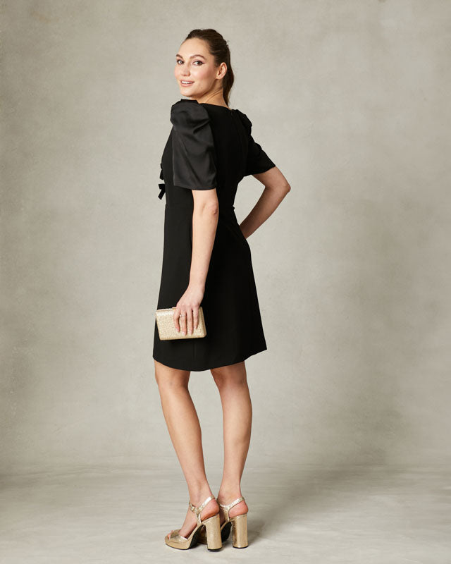 Back view of Fee G Isabelle mini dress in black with structured silhouette