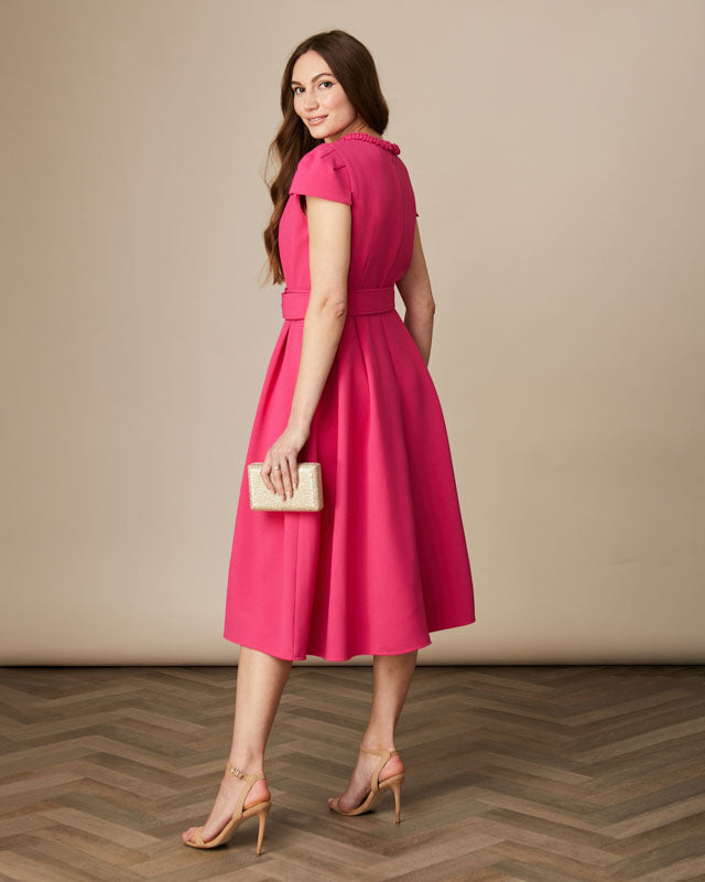 Back view of pink Fee G Charlotte dress highlighting belted A-line shape.