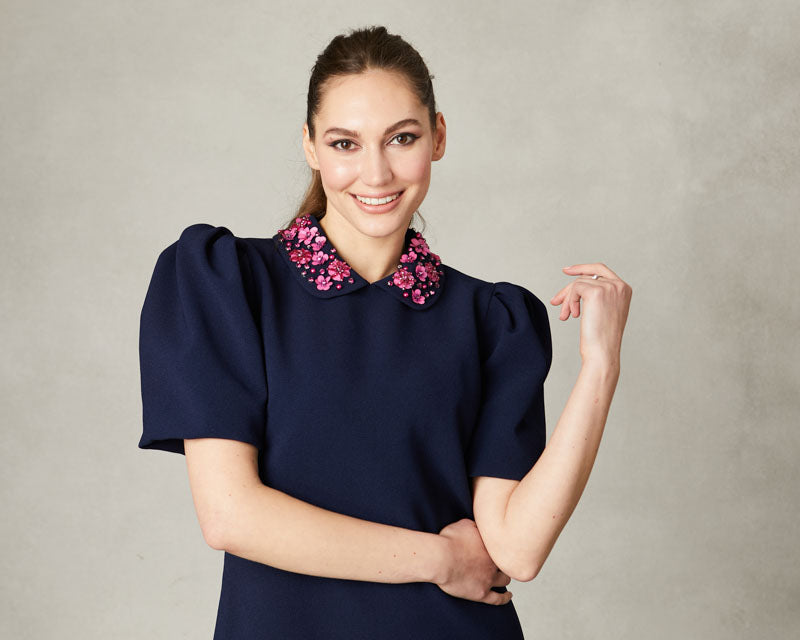 Close-up of Sabrina dress collar with pink hand-beaded gemstones.