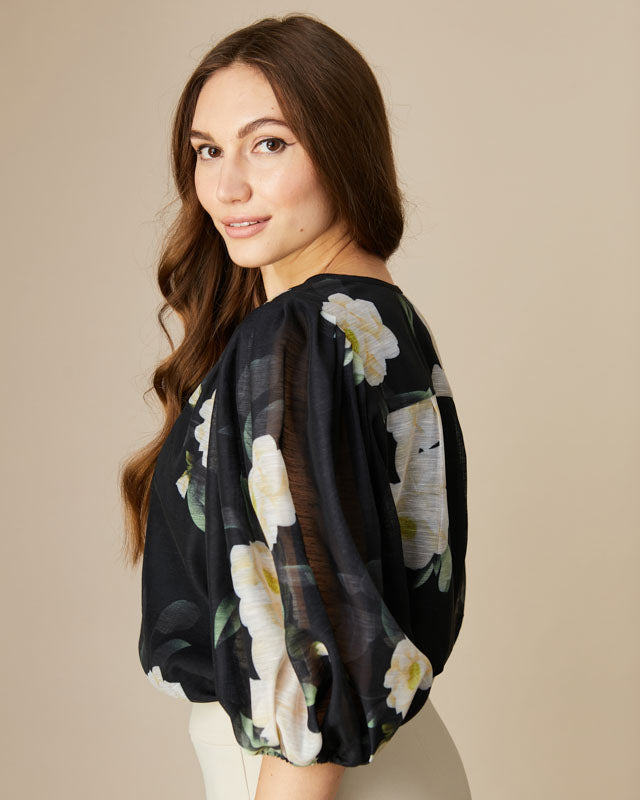 Close-up of Fee G Mila blouse showing puff sleeves and floral detail.
