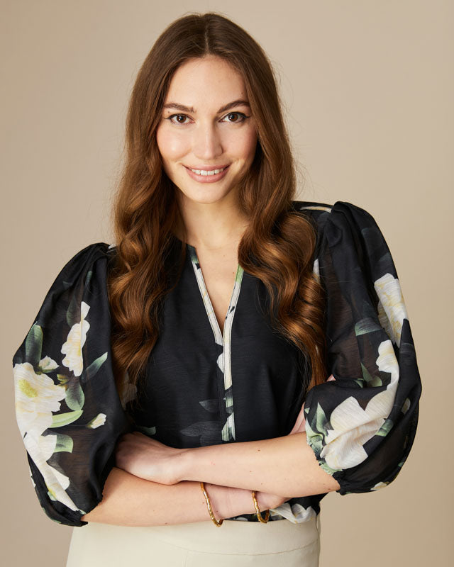 Fee G Mila black floral print puff sleeve blouse with V-neckline.