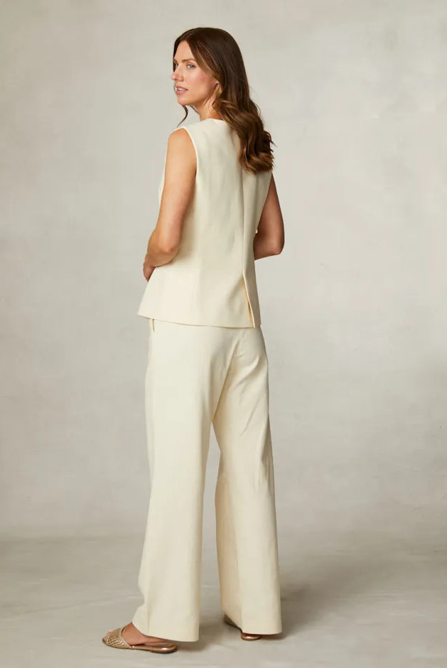 Fee G Jade yellow waistcoat worn alone with matching wide-leg trousers from back