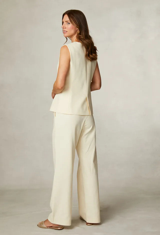 Fee G Jade yellow waistcoat worn alone with matching wide-leg trousers from back