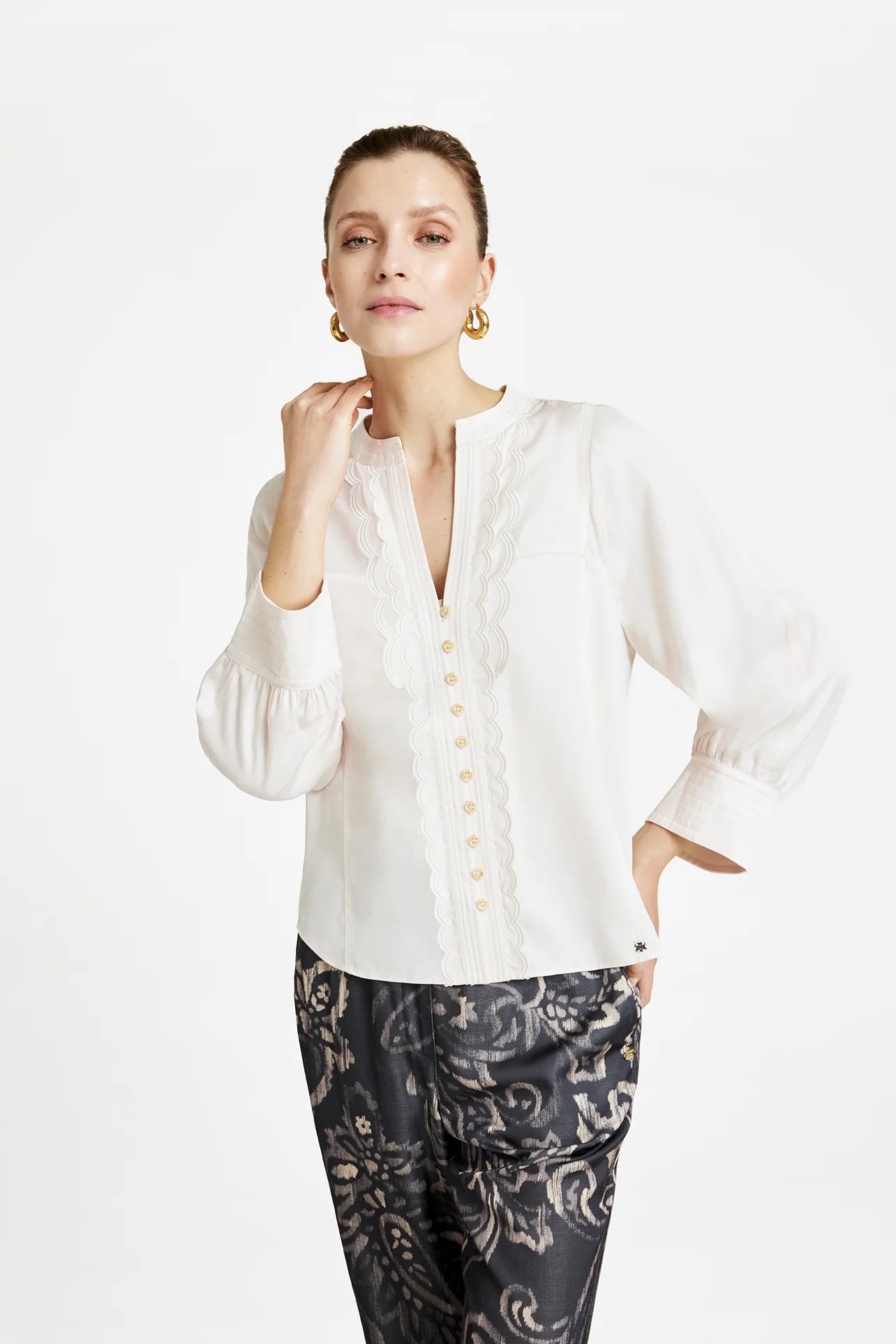 Close-up of scalloped frill trim and tonal buttons on the Gustav Kaisa cream lyocell blouse.
