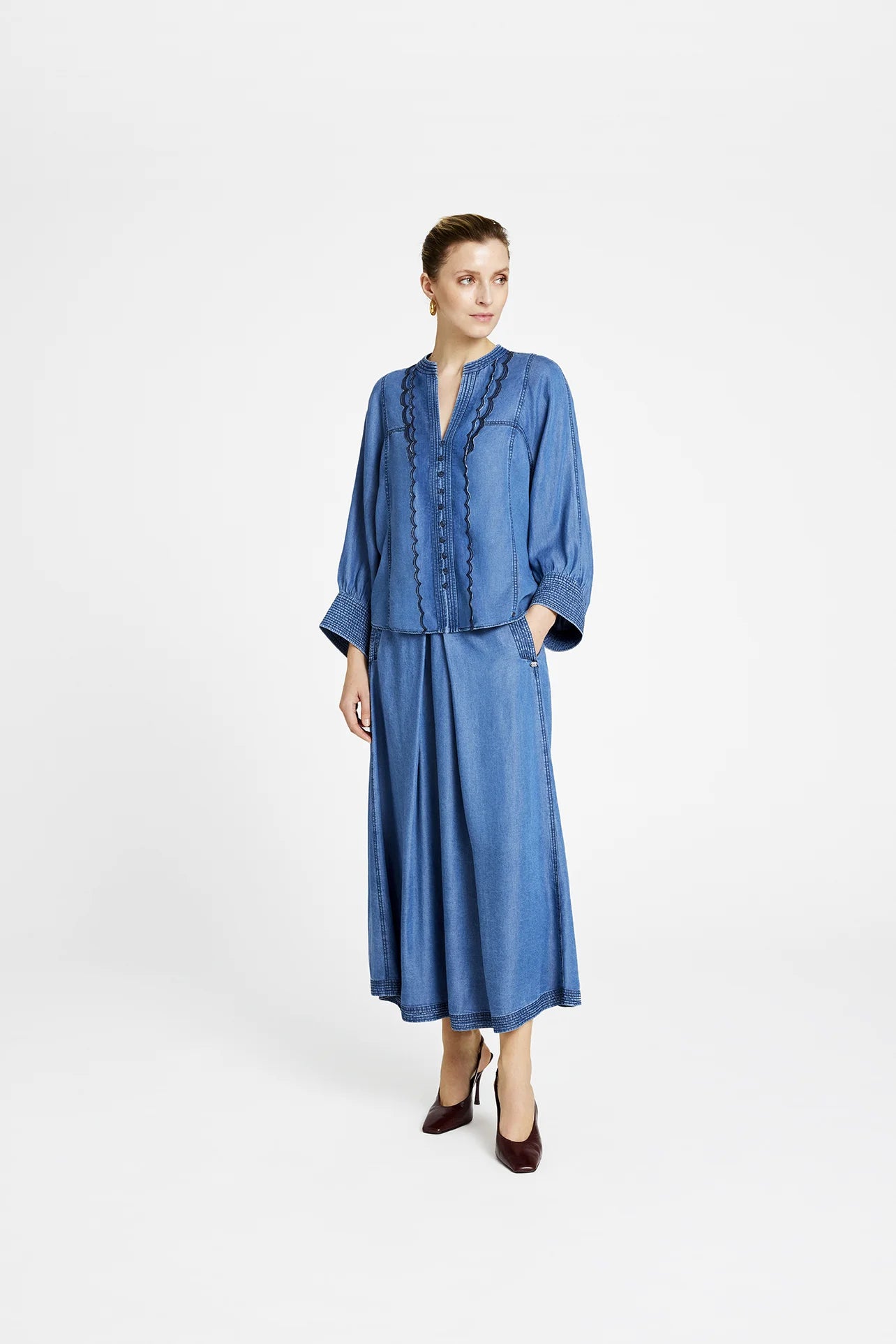 Model wearing Gustav Kaisa denim blue frilled shirt front view