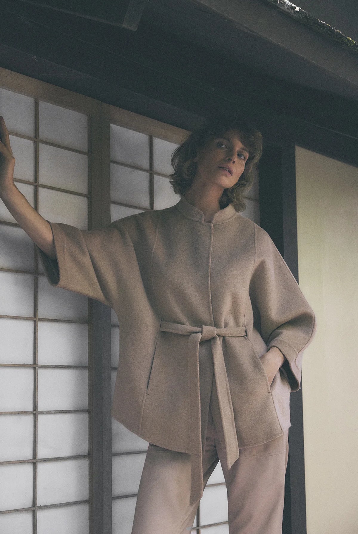 Gustav Dua camel wool blend jacket styled with matching belt and relaxed cape sleeves.