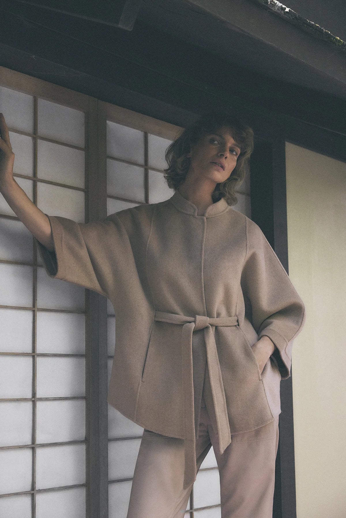 Gustav Dua camel wool blend jacket styled with matching belt and relaxed cape sleeves.