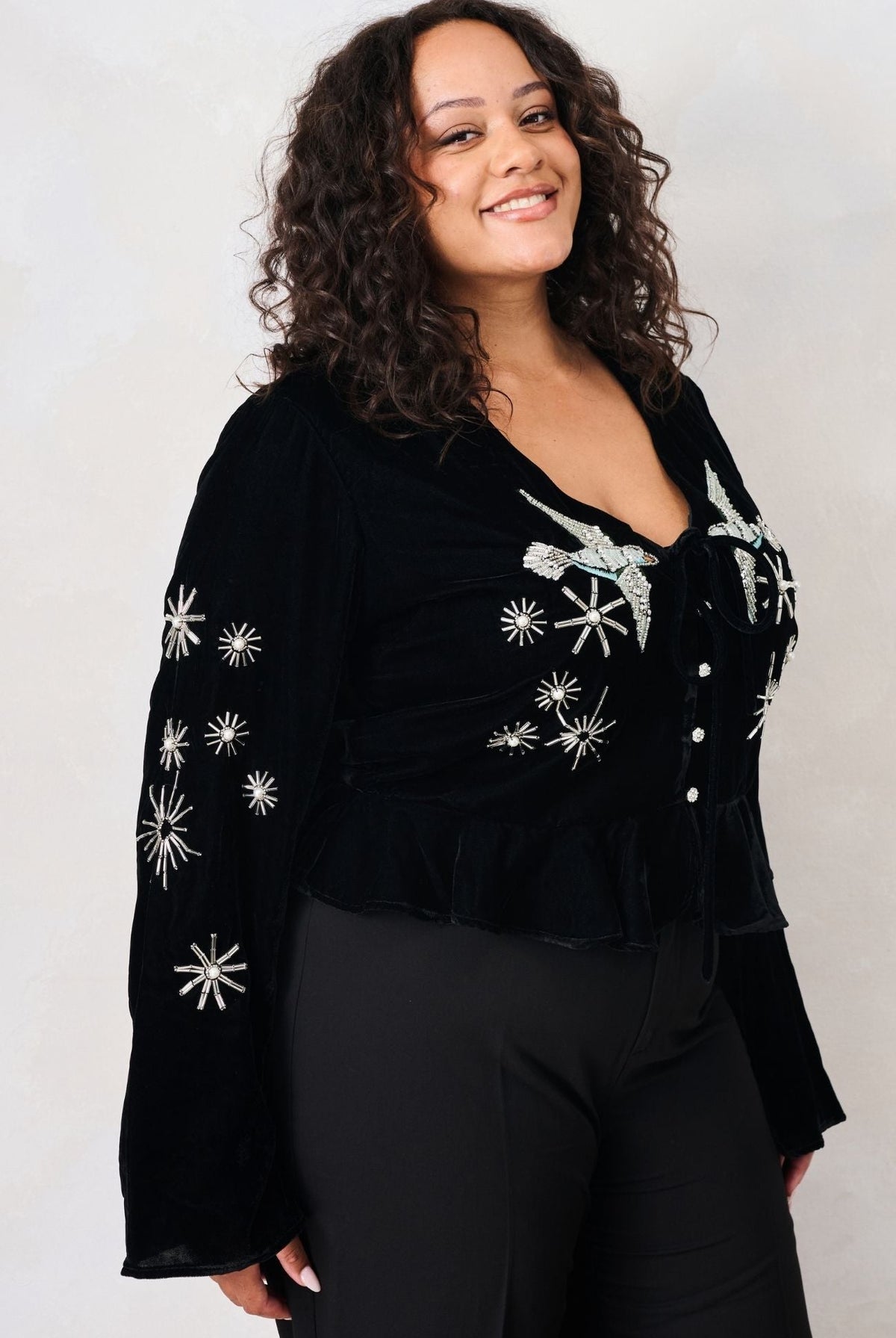 Hope & Ivy Glacia black velvet embellished party top – three-quarter curve model view