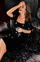 Front view of Hope & Ivy Bettina pencil dress with beaded detailing at a Christmas Party