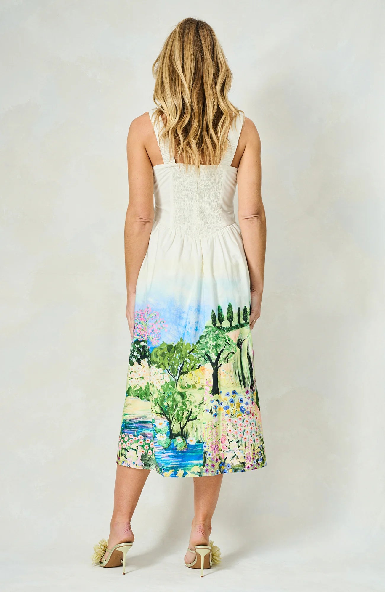 Back view of Hope & Ivy Celine dress with smocked bodice and scenic hem detail