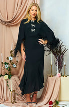 Hope & Ivy Helena embellished black midi dress – model standing against black panelling