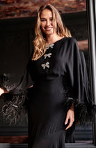 Hope & Ivy Helena feather sleeve occasion dress styled with heels – close-up front