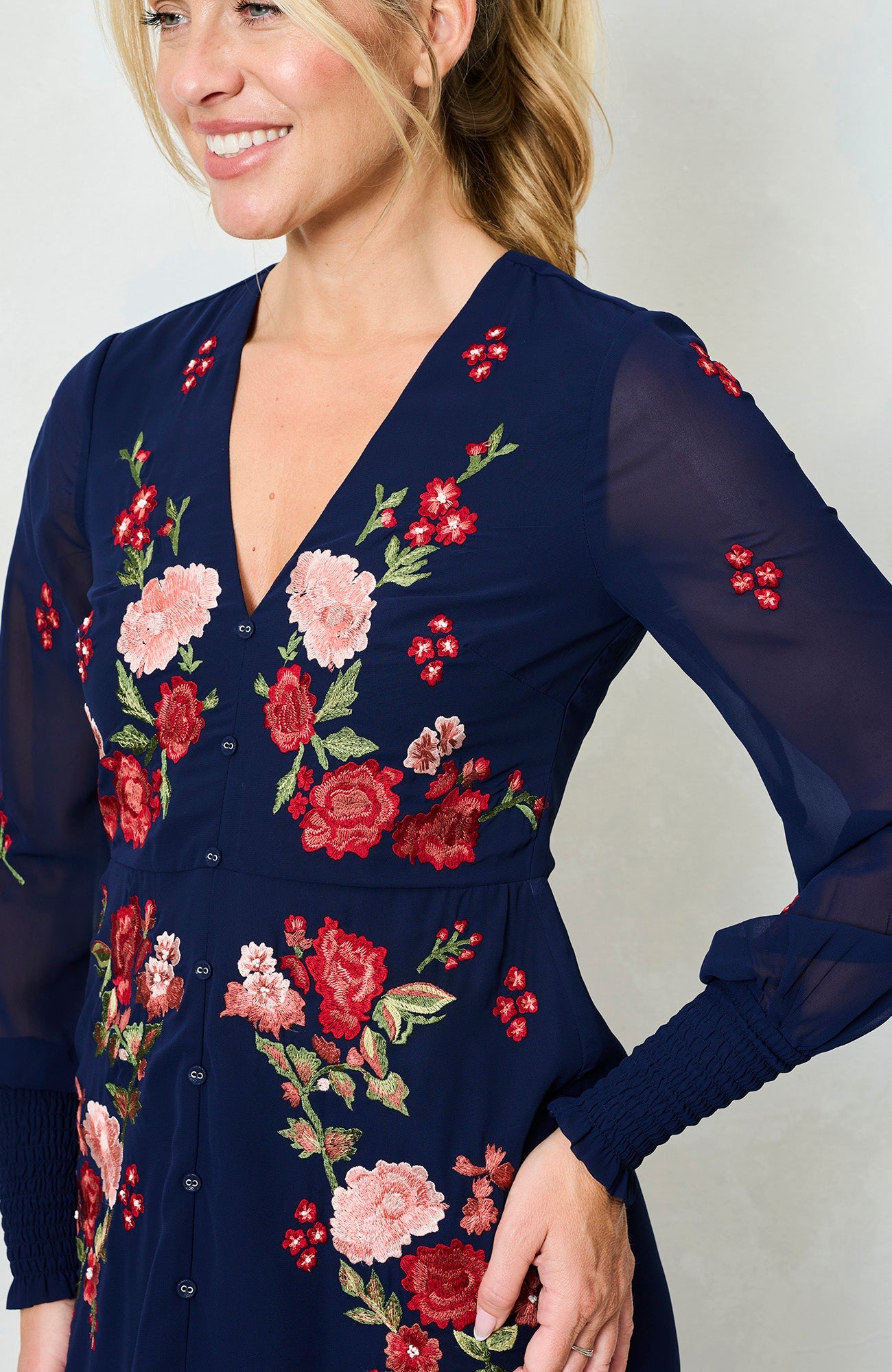 Pink and red floral stitchwork on navy Hope & Ivy V neck dress