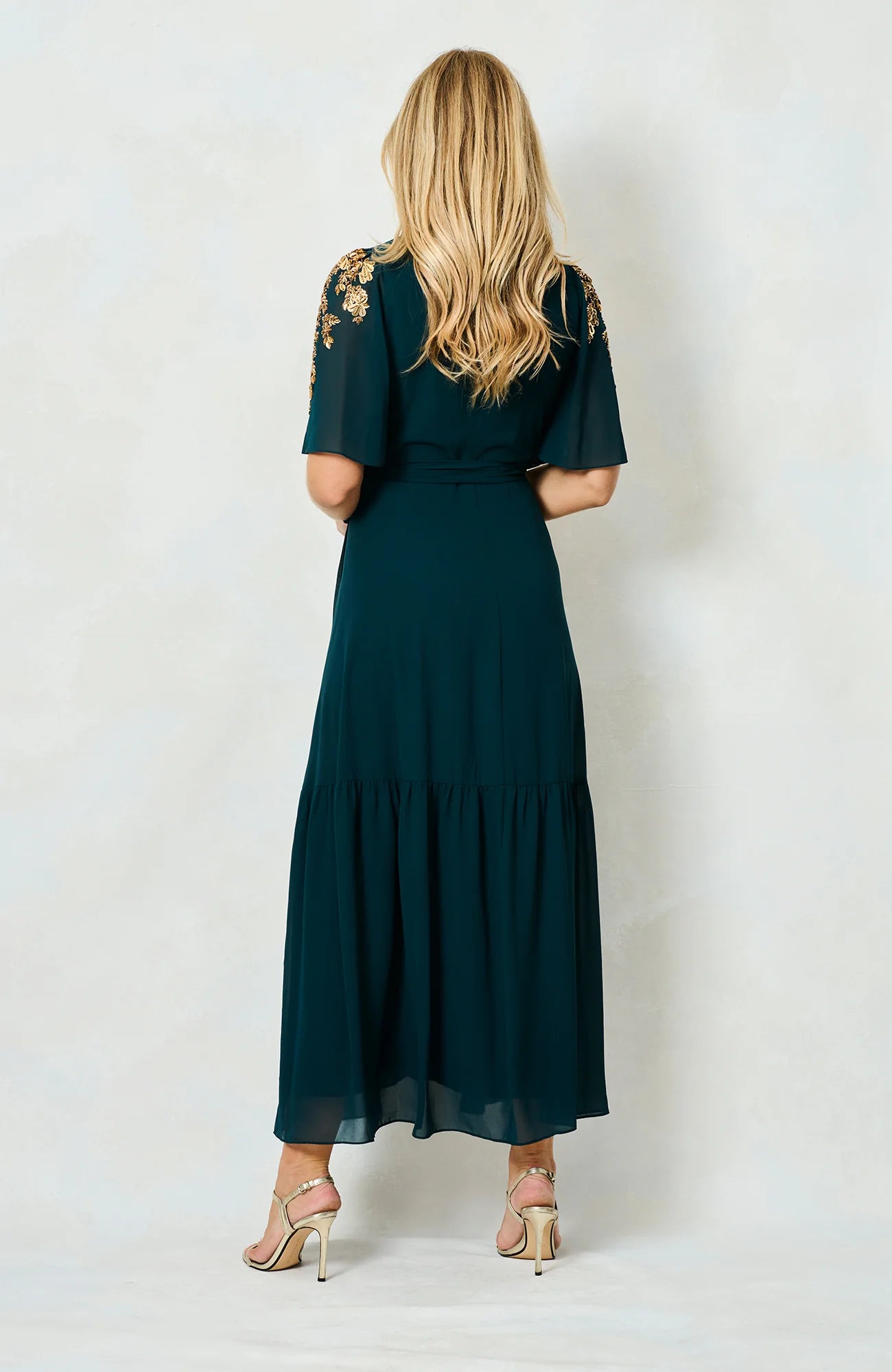 Back view of Hope & Ivy Matilda green dress with flowing hem
