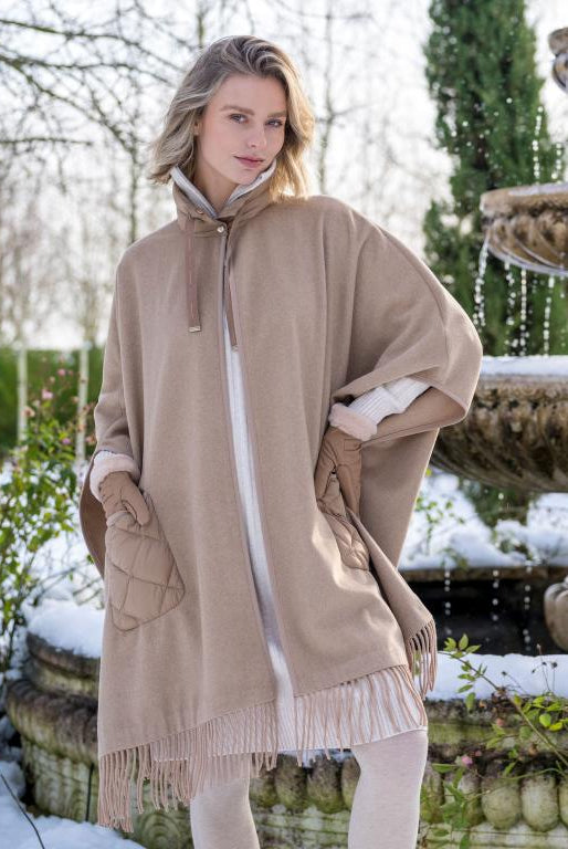 HV Society Siza camel fringed cape styled over winter layers.