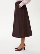 Side view of iBlues Cavallo A-line skirt in rich burgundy cotton-blend taffeta Skirt with pockets
