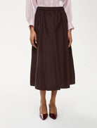 Front view of iBlues Cavallo burgundy midi skirt styled with heels
