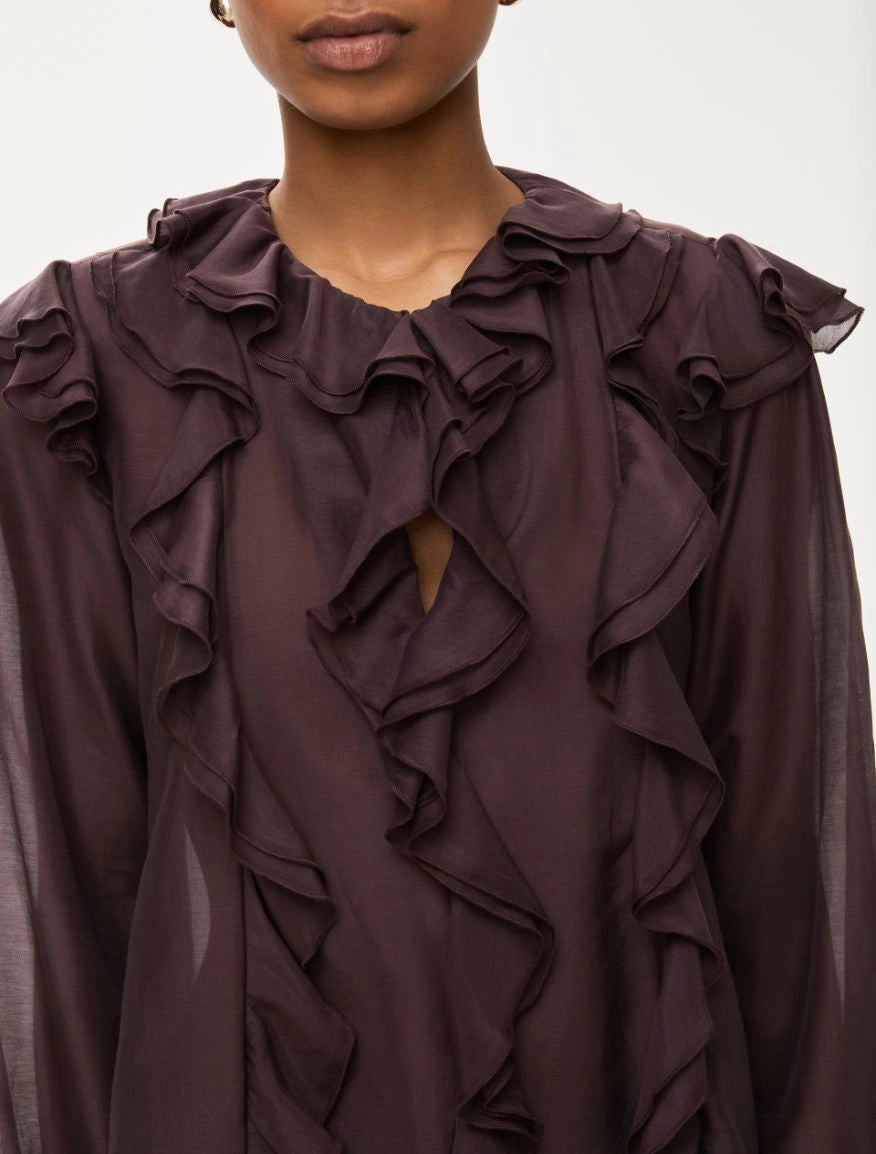 Close-up of keyhole neckline and ruffle detail on iblues burgundy blouse