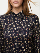 Close-up of lock and heart pattern on navy blouse