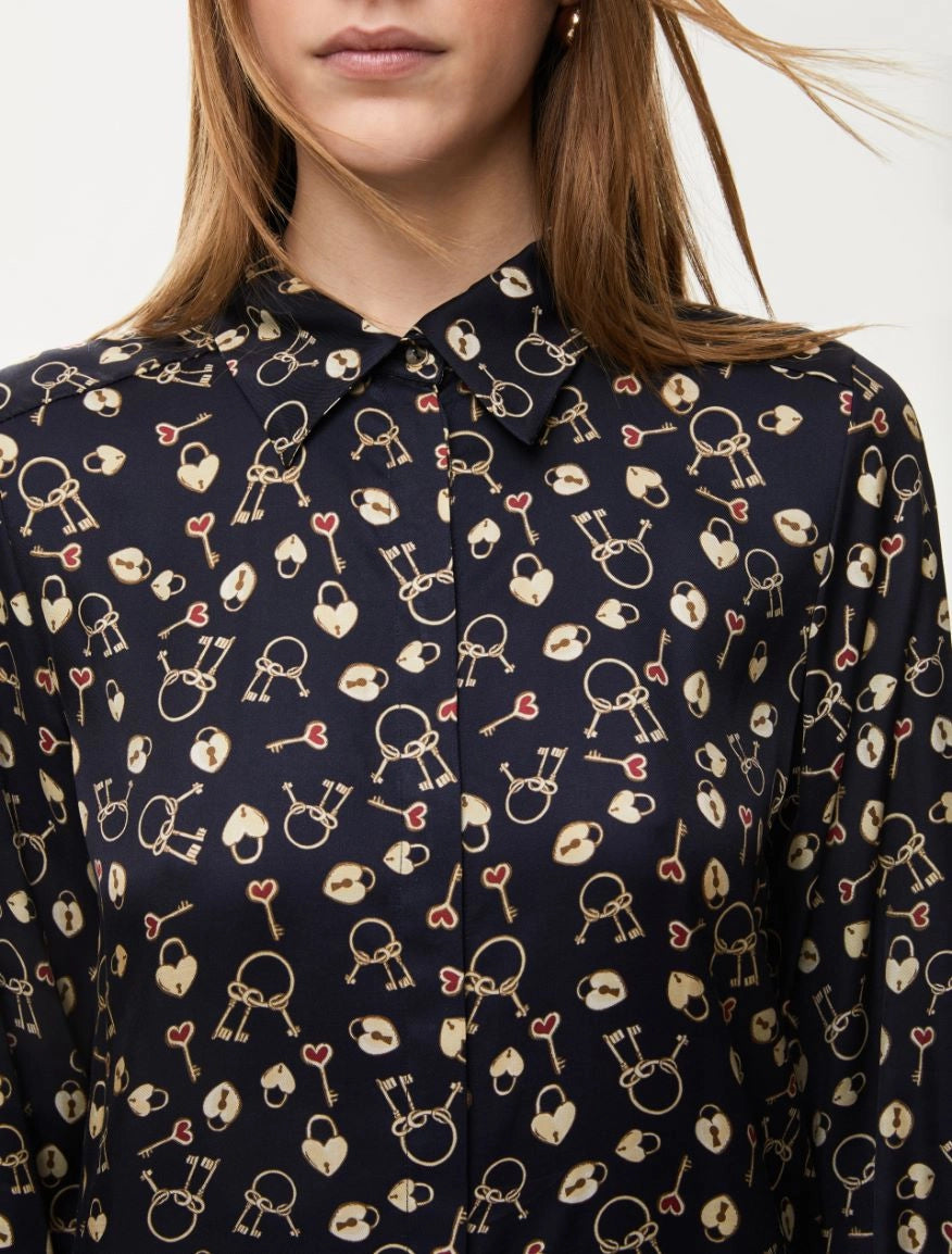 Close-up of lock and heart pattern on navy blouse