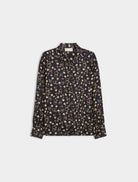 Flat lay of navy long sleeve women’s shirt with playful mini print