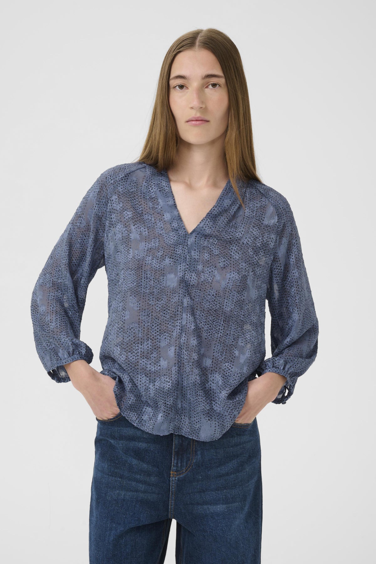 Inwear AddisonIW Blue Dot Print Blouse on woman, three-quarter front view with hands in pockets.