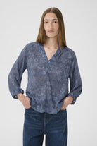 Inwear AddisonIW Blue Dot Print Blouse on woman, three-quarter front view with hands in pockets.