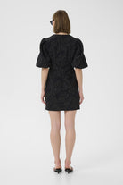 Back view of model wearing InWear Brill brocade black mini dress with structured fit