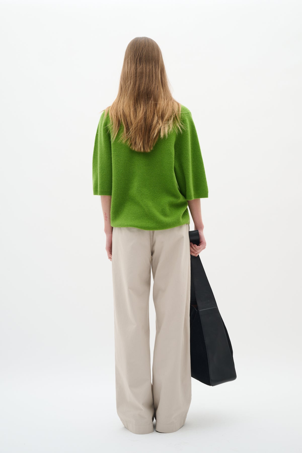 Model from behind wearing InWear Bryelle bootcut trousers in soft beige