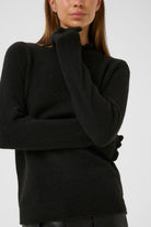 Close-up of black InWear Anaja frill high neck jumper showing sleeve and neckline.