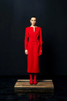 Full-length front view of Kameya red belted slit neckline dress on model